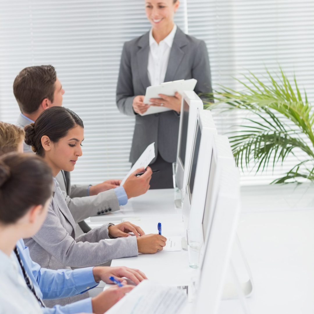 Business team writing brainstorming ideas in their notepad in the office